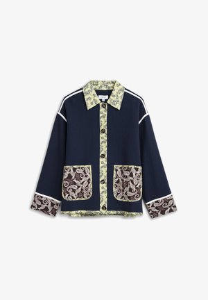 Navy jacket with paisley yellow collar, button placket, brown paisley patch pockets, and matching cuff details, white piping on shoulders and sleeves.