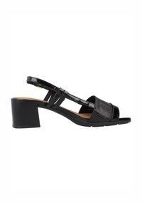 Sandal con tacco chunky nero a slingback, realizzata con materiale lucido e testurizzato, design open toe e multiple cinghie che attraversano il piede.
