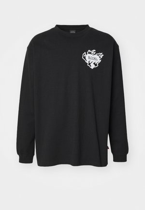 Čierne tričko s dlhými rukávmi vyrobené z bavlny, s bielym logom v tvare plameňa na ľavej hrudi a okrúhlym výstrihom.