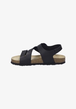 Black sandal featuring cross straps, adjustable buckle, and a cork-like sole with a textured finish. Lightweight design with a flat heel.