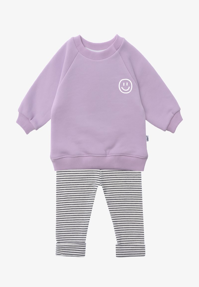Lavender long-sleeve sweatshirt with white smiley face on chest paired with white and black striped pants with cuffs.