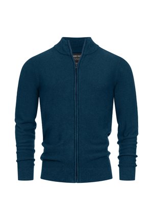 Cárdigan de punto con cremallera frontal en verde azulado oscuro. Presenta un cuello y puños acanalados, tejido texturizado y un diseño ajustado con mangas largas.
