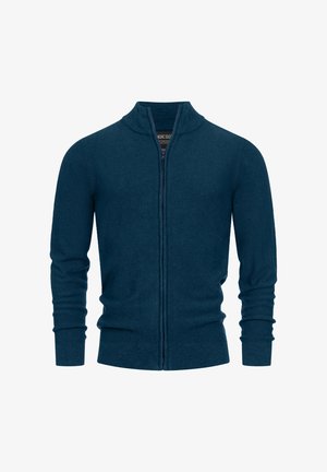 Cardigan in maglina con zip di colore verde scuro. Presenta colletto e polsini a coste, tessuto testurizzato e design aderente con maniche lunghe.