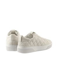 Quilted light gray sneakers with a smooth leather finish, rounded toe, and rubber sole featuring textured stripes and a pull tab at the heel.