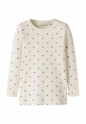 Cremefarbenes Langarmshirt mit Rippstruktur und kleinen roten Herzmustern, die gleichmäßig über den Stoff verteilt sind.