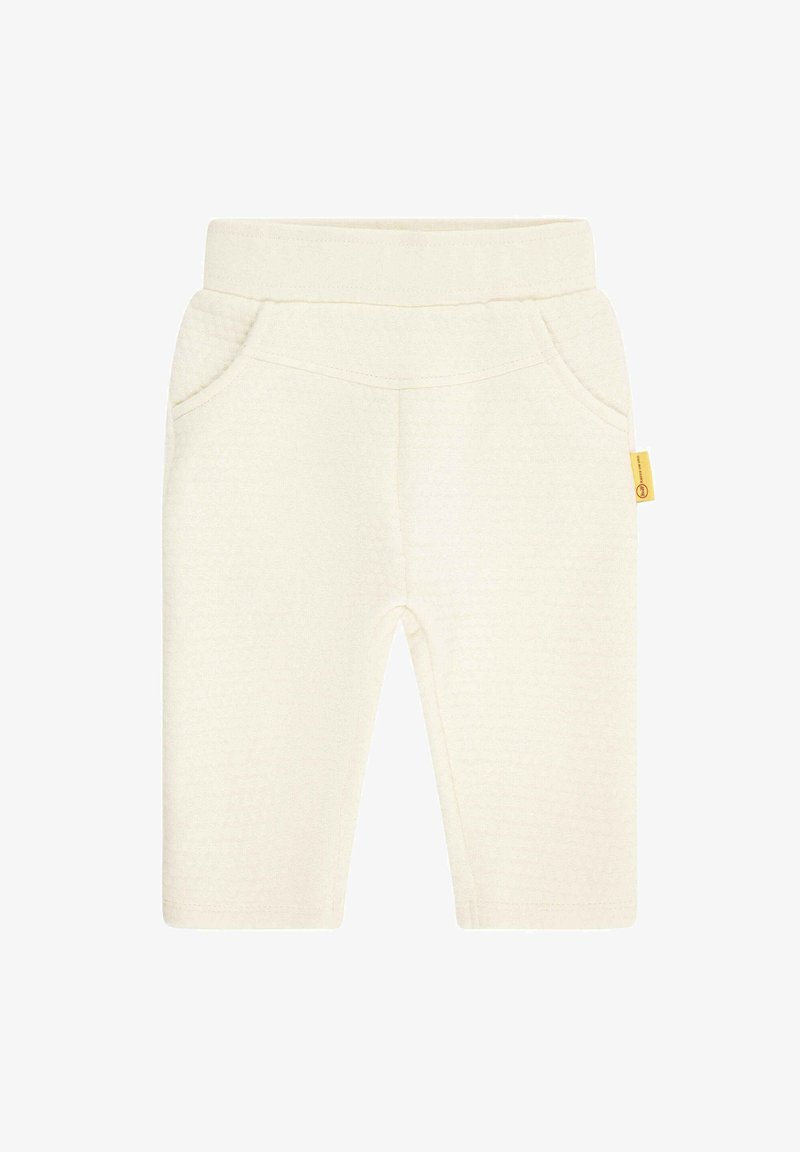 Cream-colored toddler pants made of soft fabric, featuring a smooth texture, elastic waistband, and two side pockets. Yellow brand tag attached.