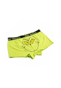Boxer shorts verdi con una stampa del volto del Grinch, occhi gialli e una cintura nera decorata con la scritta "MERRY GRINCHMAS." Materiale in cotone morbido.
