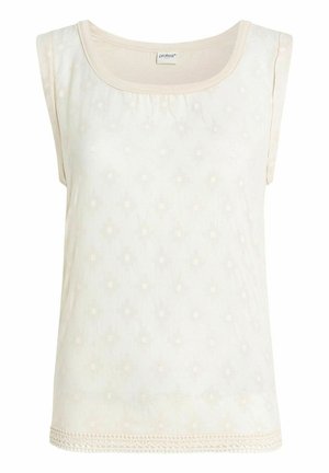 Jasno beżowy, bezrękawnik z teksturowanym wzorem i falbanistym brzegiem. Okrągły dekolt z delikatnymi detalami przeszycia. Miękka tkanina.