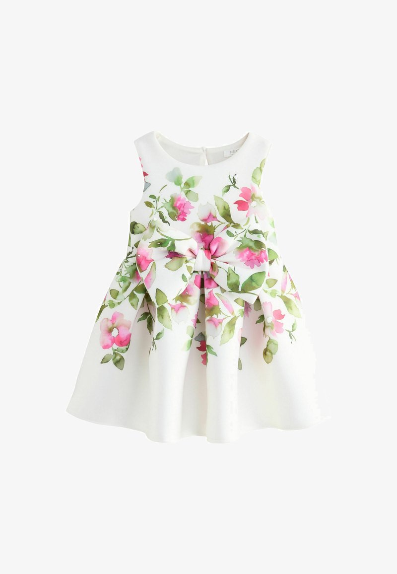 White sleeveless baby dress with pink and green floral print and large matching bow on the front.