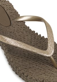 Brown flip-flop with a textured rubber sole and a glittery gold strap. The strap has a curved design for a secure fit.