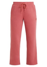 Roze sweatpants met een trekkoord in de taille, gemaakt van zachte stof, met een recht gesneden ontwerp en minimale merkvermelding aan de zijkant.