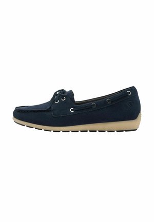 Navy blue suede moccasin-style shoe with beige sole, decorative laces, and metal eyelets, featuring a rounded toe and flat profile.
