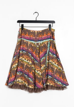 Brown skirt with colorful abstract tree patterns, a side zipper, aqua blue tie, and a sheer ruffled hem, hanging on a black hanger.