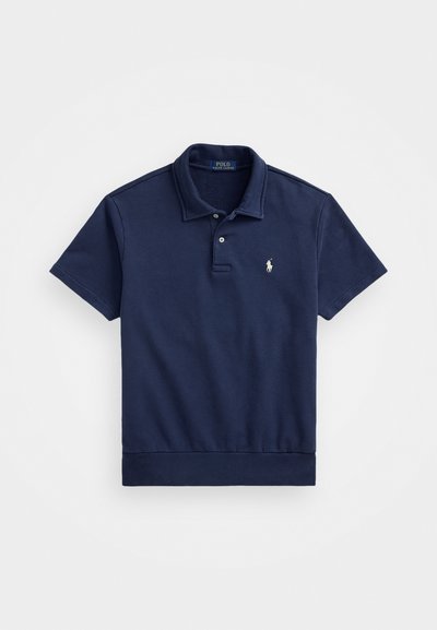Navy blue polo shirt made of cotton, featuring a classic collar, two-button placket, short sleeves, and a small embroidered logo on the chest.
