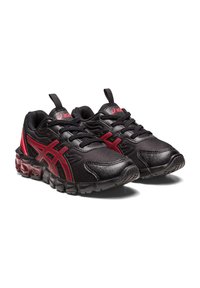 Black athletic shoes with red accents, mesh material, textured surface, and a cushioned sole. Features laces and a pull tab on the heel.