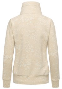 Pullover beige chiaro con colletto alto, caratterizzato da un motivo floreale in una tonalità leggermente più scura. Tessuto texturizzato con orlo e polsini a coste.