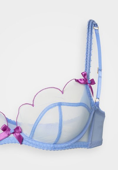 Light blue sheer bra with scalloped edges, accented by purple satin bows, adjustable straps, and lace trim along the edges.