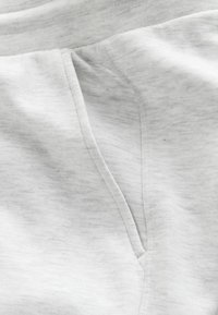 Light gray cotton fabric with a subtle heather pattern, featuring a side pocket and visible stitching along the edges.