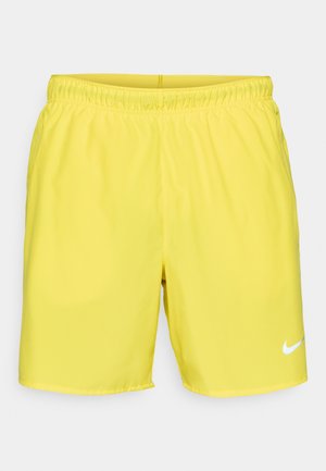 Shorts de bain jaunes en tissu lisse et léger, dotés d'une taille élastique et d'un logo Nike blanc sur le bas à droite.