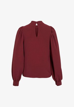 Burgundy blouse with puffed sleeves, keyhole back detail, and buttoned cuffs. Made from textured fabric, offering a relaxed fit.