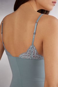 Lichtblauw camisole met verstelbare banden, met een delicate kantafwerking langs de halslijn. Glad materiaal, slank model, naadloze achterkant.