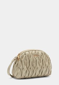 Beige gesteppte Handtasche aus synthetischem Leder mit einem Reißverschluss, einem Seitenriemen und einem dezenten Logo- akzent aus goldfarbenem Metall.
