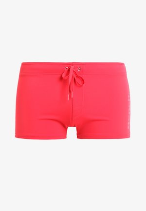 Pink swim shorts made of smooth, stretchy material. They feature a drawstring waistband and a small logo on the side.