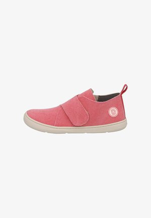Pink slip-on shoe with wide Velcro strap, white sole, fabric pull tab at heel, and round logo patch on outer side.