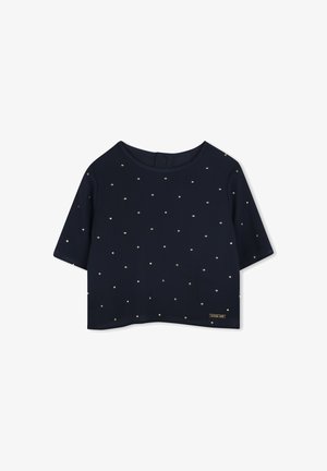 Top court bleu marine avec des manches courtes, un col rond, et orné de petits clous dorés sur le tissu. Étiquette sur le côté.