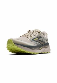 Light beige trail running shoes with a breathable upper, patterned gray accents, and a textured green outsole for grip. Logo on the side.