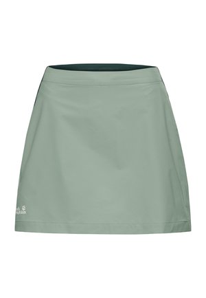 Jupe d'extérieur vert clair à coupe droite, taille élastique et logo Jack Wolfskin proche de l'ourlet inférieur.