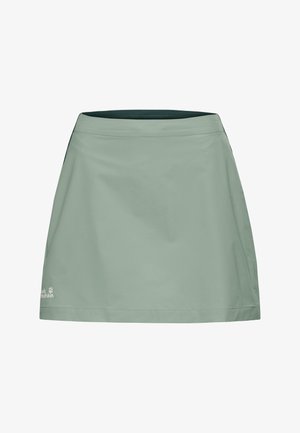 Jupe d'extérieur vert clair à coupe droite, taille élastique et logo Jack Wolfskin proche de l'ourlet inférieur.