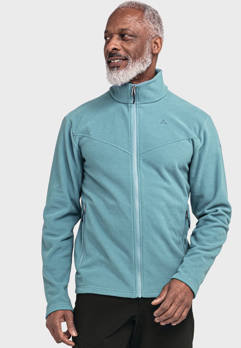 Helle blaue Fleecejacke mit hochgeschlossenem Reißverschlusskragen, Seitentaschen und strukturiertem Finish. Mit einem geometrischen Nahtdesign auf der Brust.