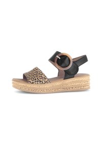 Black and tan platform sandals with leopard print leather upper, adjustable strap, and round wooden accent, featuring a woven textured sole.
