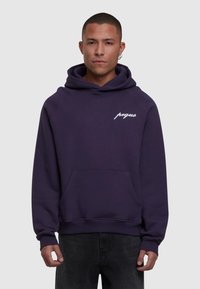 Violeta kapuce ar kangaroo kabatu, aukliņu kapuci un balto "peqaus" logotipu kreisajā krūtī. Mīksta tekstūra un brīvi pieguļošs stils.