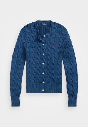 Dark blue knitted cardigan with cable pattern, five white buttons down the front, ribbed cuffs and hem, and a small logo on the chest.