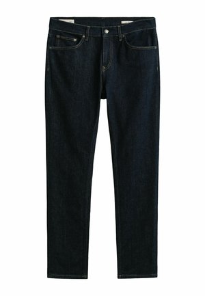 Jean droit indigo foncé avec cinq poches, couture apparente, et fermeture par bouton et fermeture éclair à la taille.