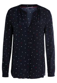 Navy long-sleeve shirt with a v-neck, featuring a scattered star pattern in red, white, and blue. Soft fabric, relaxed fit.