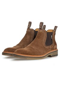 Bottes Chelsea en daim marron avec panneaux élastiques sur les côtés, languettes pour tirer, et talon empilé ; intérieur en cuir lisse et détails de couture contrastants.