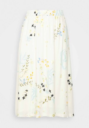 Jupe midi blanche avec taille élastique, ornée d'un léger motif floral aux accents bleus, jaunes, verts et noirs.