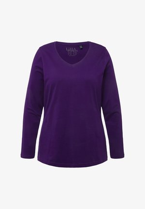 Fialová dlhá polokošeľa s výstrihom do V vyrobená z mäkkej bavlnenej tkaniny. Má rovný lem a voľný strih, bez ďalších vzorov alebo akcentov.