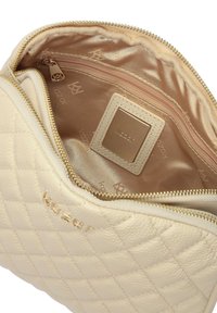 Pochette in pelle trapuntata di colore beige chiaro con zip dorata, foderata in satin. Presenta una piccola etichetta con logo e una tasca con zip aggiuntiva all'interno.
