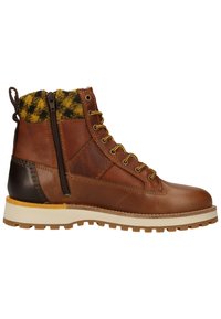 Brown leather boot with a yellow and black patterned collar, side zipper, and textured rubber sole. Features contrasting heel and lacing design.