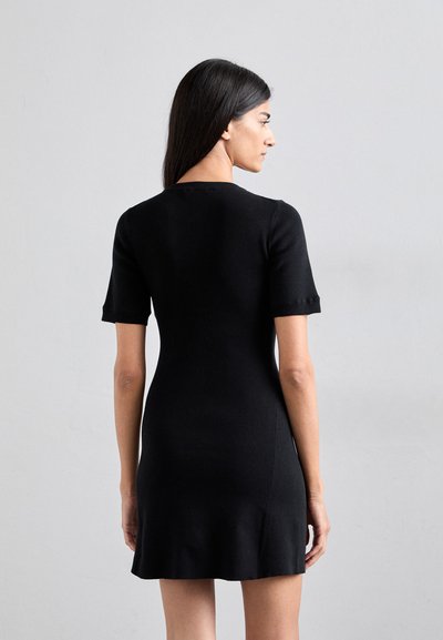 Black ribbed dress featuring short sleeves, a fitted silhouette, and a flared hem. Smooth texture with a round neckline.