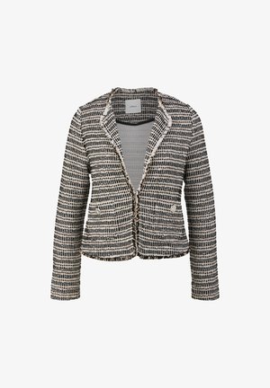Giacca in tweed bianco e nero con un design aderente, rever a punte, bordi sfrangiati e due tasche frontali. Tessuto strutturato e textured.