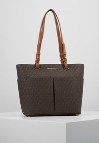 Sac cabas monogramme marron en matériau synthétique texturé. Doté de deux bretelles, d'une fermeture éclair supérieure et de deux poches avant ouvertes.