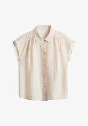 Blouse beige clair à manches courtes avec un devant boutonné, en tissu doux et texturé, et un col classique avec de subtils fronces aux épaules.