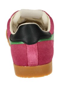 Pink suede sneaker with black leather accents, green stripe, and a gum rubber sole. Soft, plush interior padding visible.
