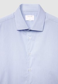 Light blue striped dress shirt with a slim fit, featuring a pointed collar, white buttons, and a soft fabric texture. Label reads "Caillebotte Man, L."