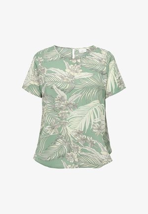 Blouse verte à manches courtes avec motif de feuilles et de fleurs tropicales blanches et beiges, col rond et fermeture par boutons au dos.